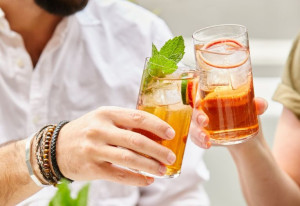 People holding tall glasses of Regal Rogue aperitif.