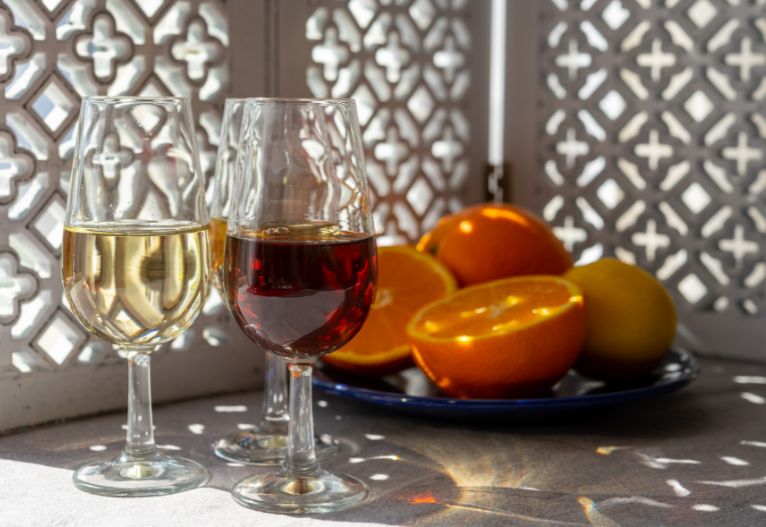 Red and white fortified wine in glasses.