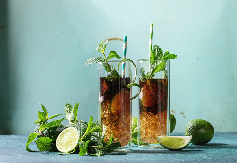 Coke-based mixed drinks with lime and mint.