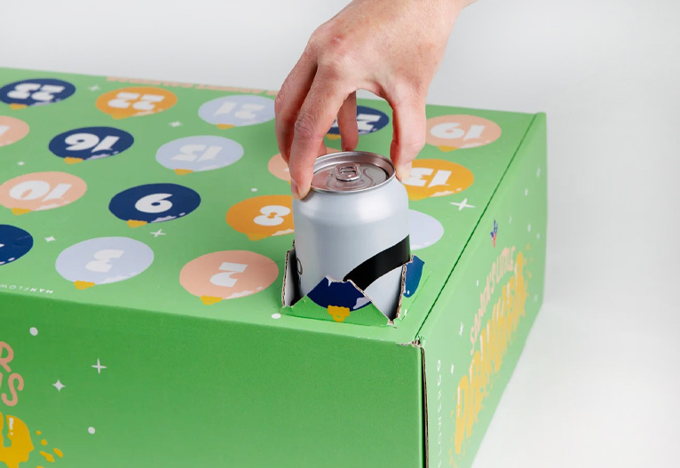 Person pulls a can out of an advent calendar box.