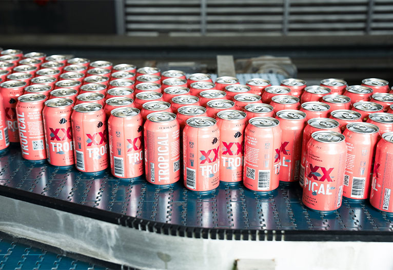 XXXX Tropical Lager cans in production.