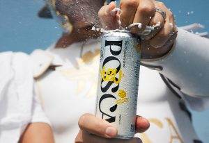 Person in gladiator outfit opening a can of POSCA Hydrate.