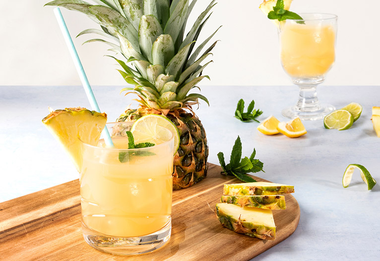 Pineapple cocktail on a wooden board.