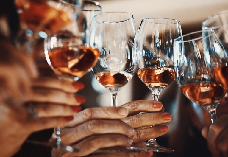 People holding glasses of wine.