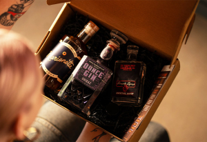 Woman holding a cocktail subscription box.