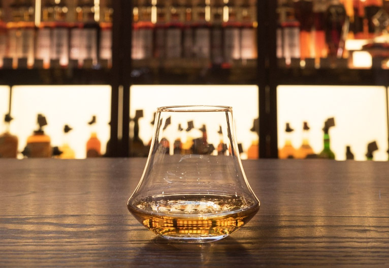 Denver & Liely Whisky Glass on a bar.