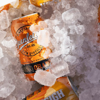 Beenleigh Hard Orange Crush can in ice box.