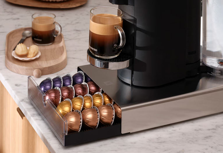 Nespresso capsule drawer open and filled with capsules.