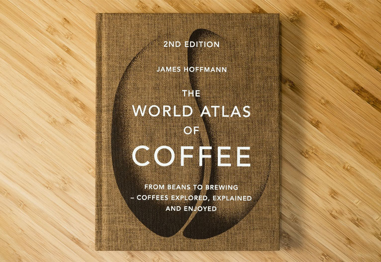 The World Atlas Of Coffee book on a table.