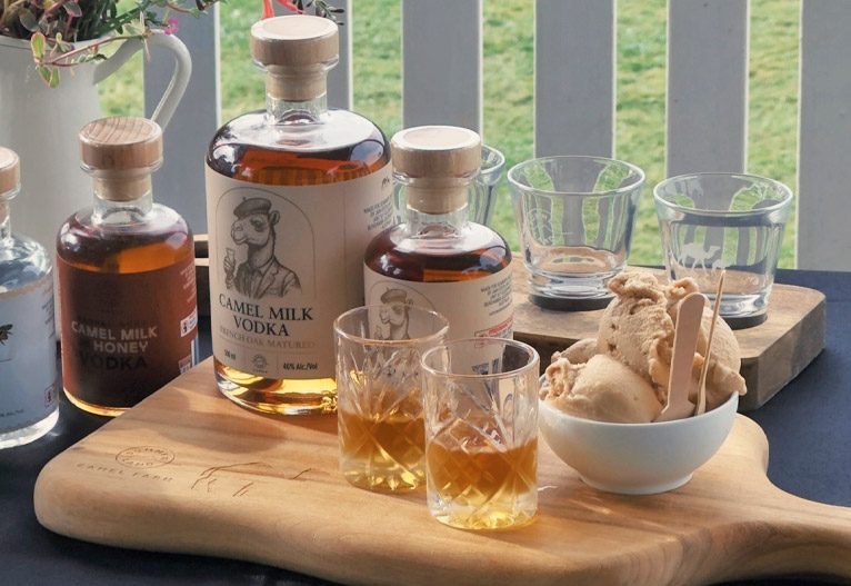 Camel Milk Vodka products on a table with a bowl of gelato.