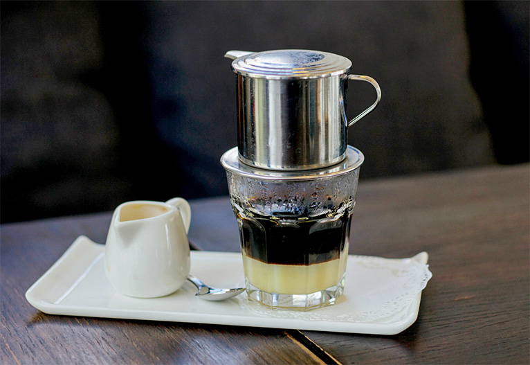 Vietnamese iced coffee on a bench.