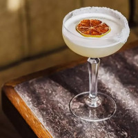 Margarita cocktail with dehydrated fruit garnish.