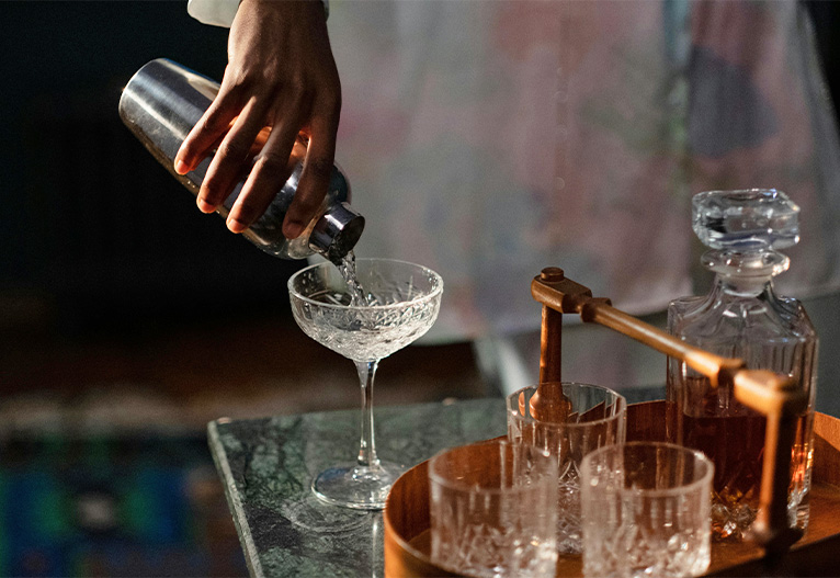 Person pouring a cocktail.