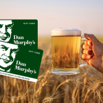 Person holding a mug of beer.