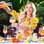Woman pouring from a carafe into a wine glass.