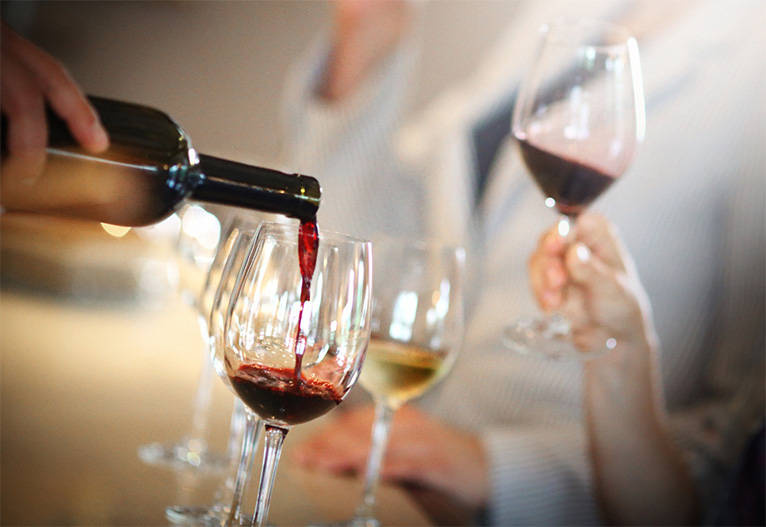 People holding glasses of wine.