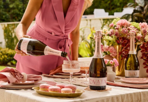 Table setting with lady pouring sparkling OVATA.