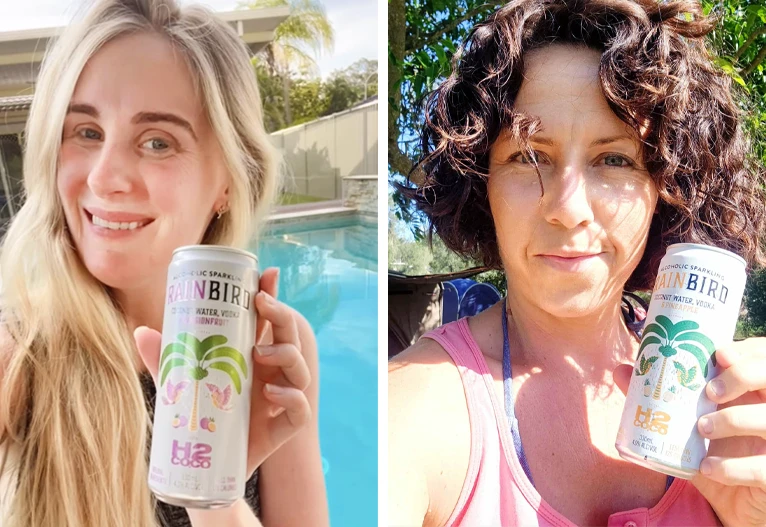 Two woman holding cans of Rainbird x H2coco Vodka premixes.