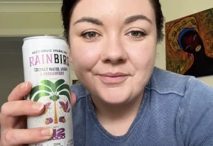Woman holding a can of Rainbird Coconut Water Vodka Passionfruit.