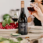 Women drinking Taylor Made Pinot Noir at a table.