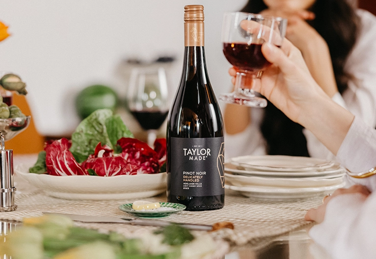 Women drinking Taylor Made Pinot Noir at a table.