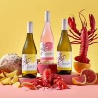 Lobster Reef Flavours wines on a table with seafood and citrus fruit.