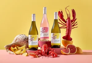 Lobster Reef Flavours wines on a table with seafood and citrus fruit.