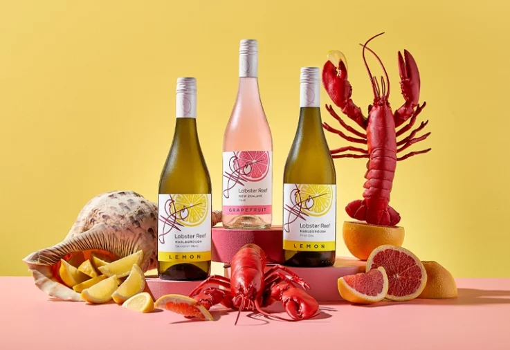 Lobster Reef Flavours wines on a table with seafood and citrus fruit.